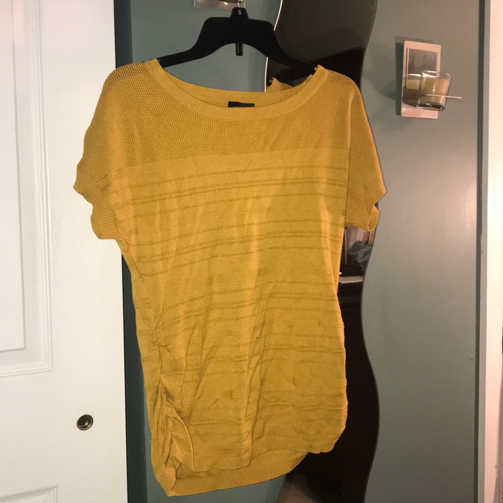 Mustard yellow short sleeve shirt.